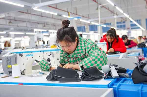 Outdoor jackets are manufactured in a workshop of a company in Sanmen County.