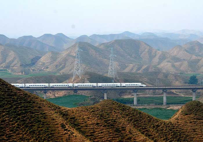 A bullet train cuts across the vast Gobi landscape in Zhongchuan township.